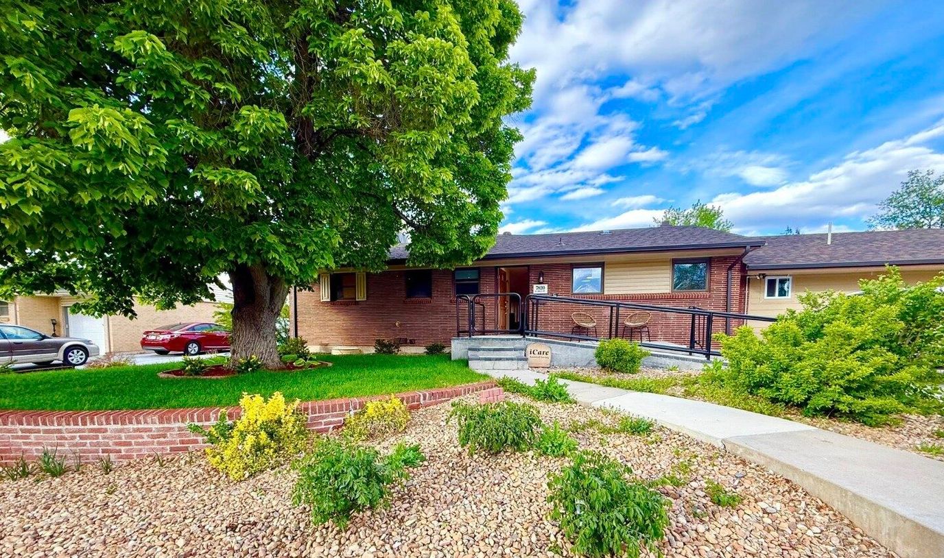 Exterior view of an assisted living residence with landscaping