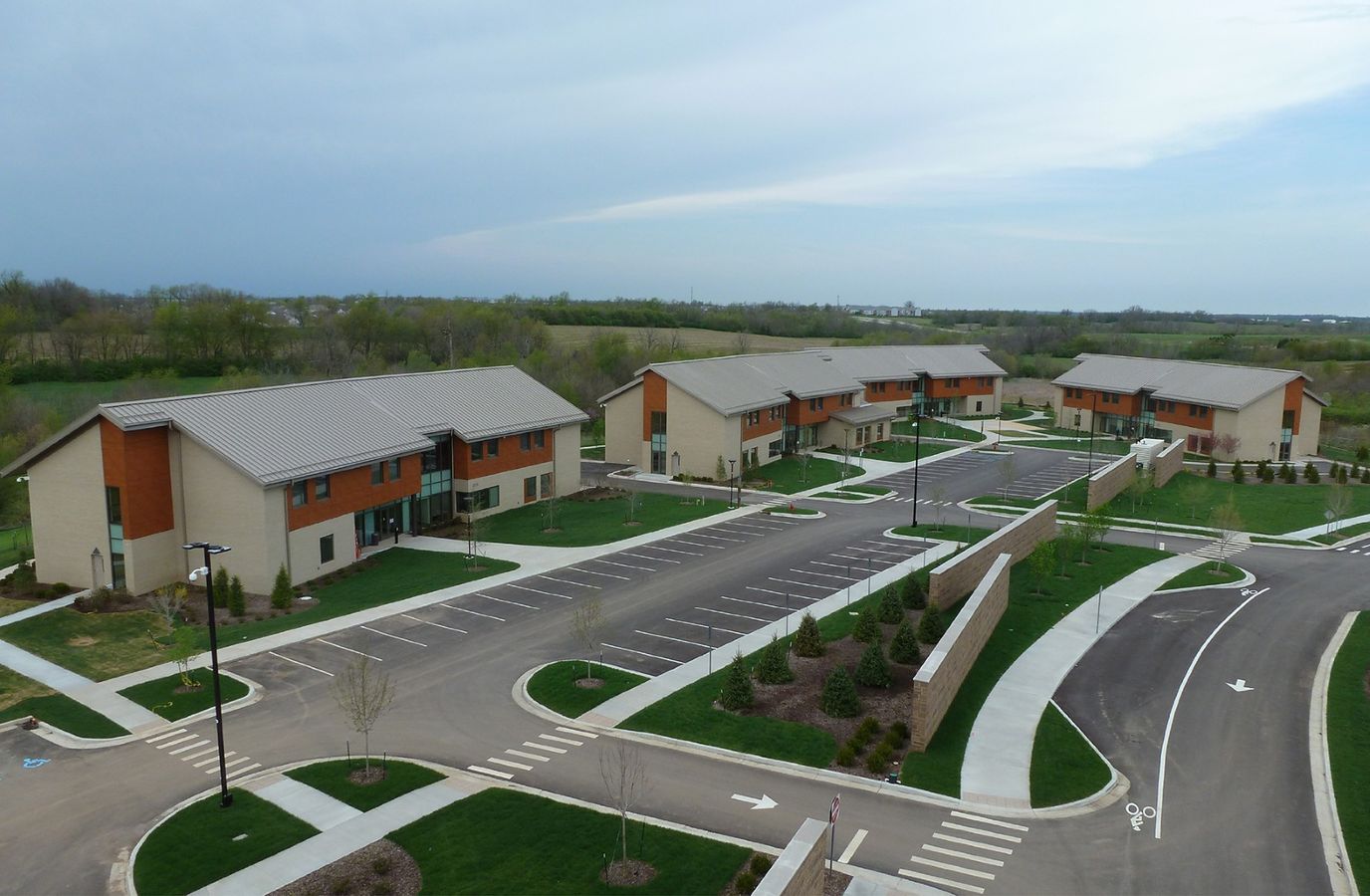 Aerial view of a residential building complex with parking