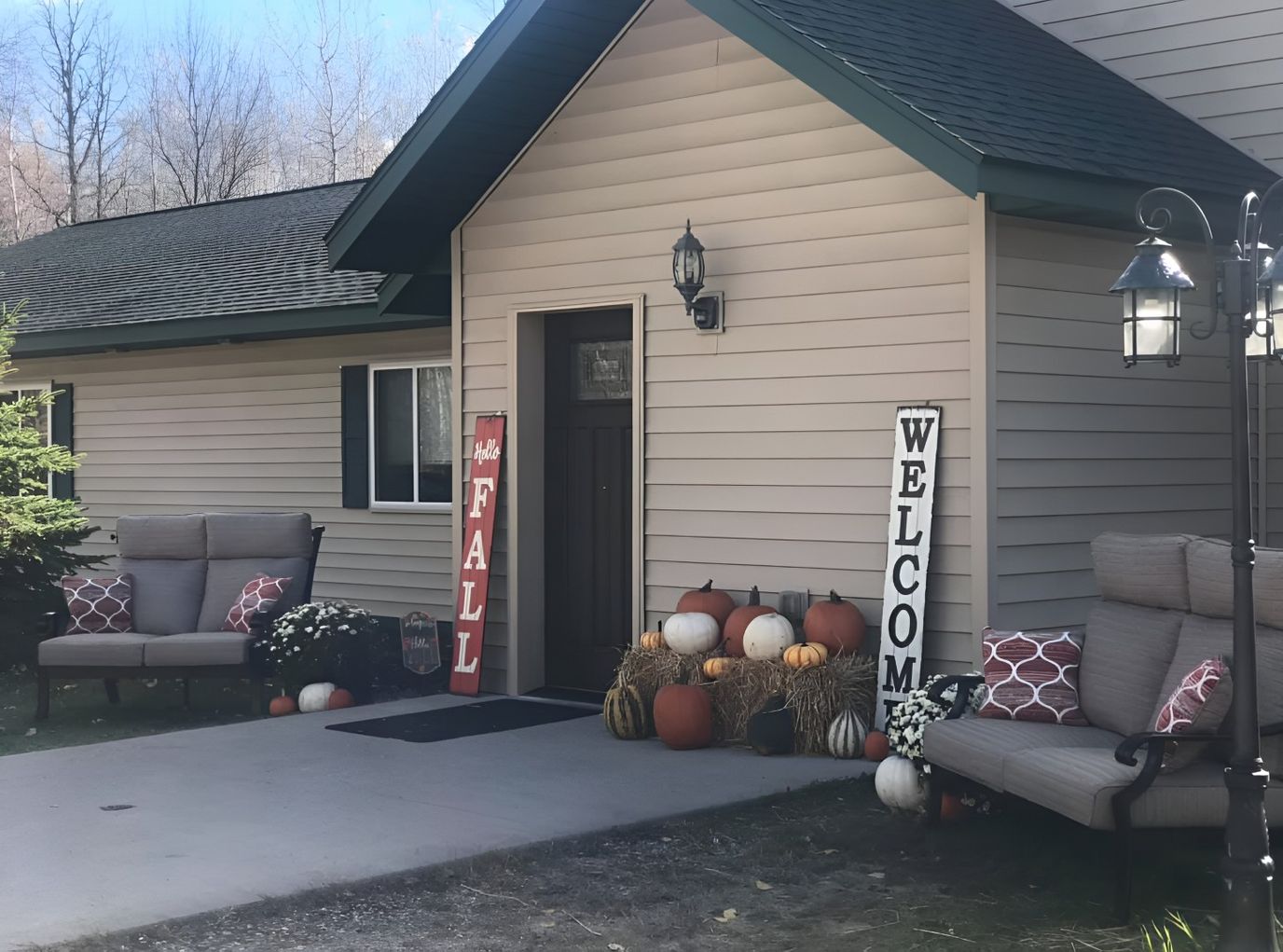 Exterior view of a welcoming entrance with autumn decor