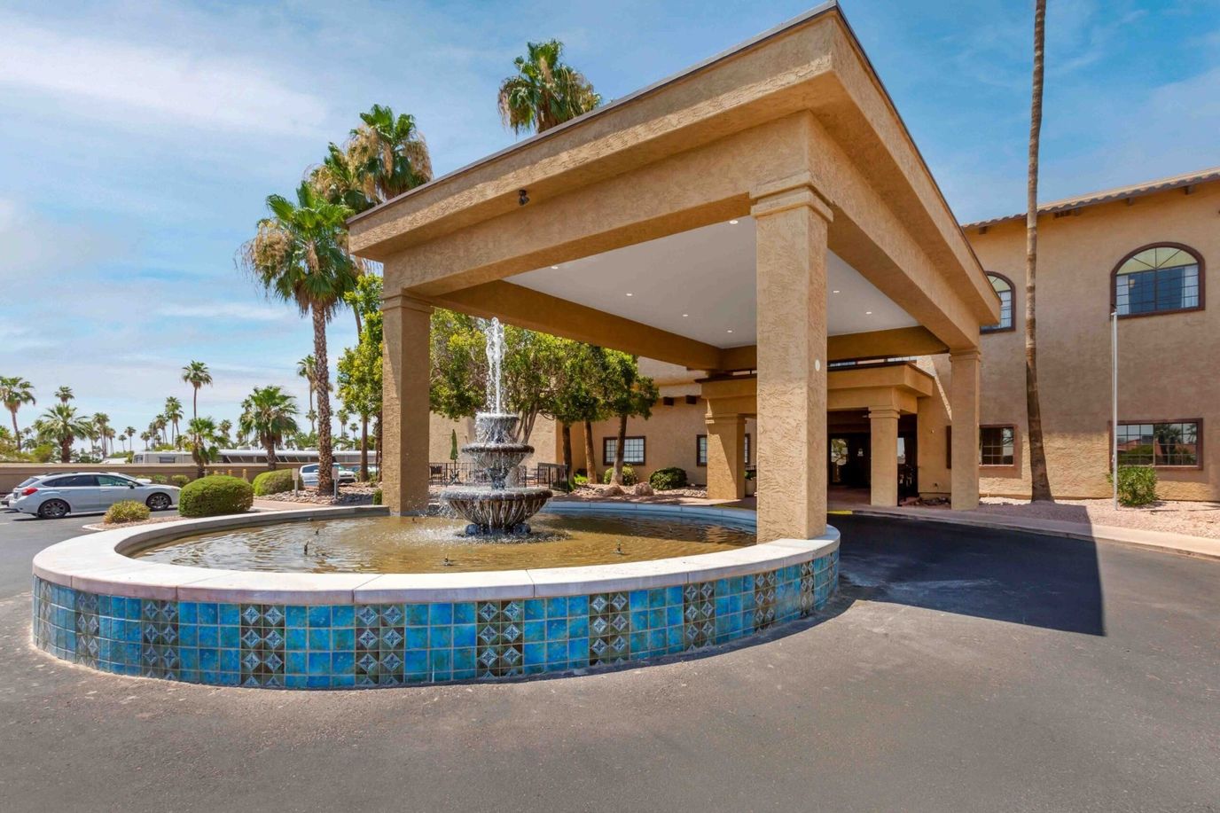 Exterior view of assisted living facility entrance with fountain