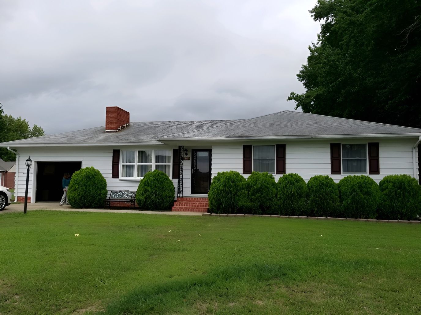 Front exterior of a senior care facility with landscaped yard