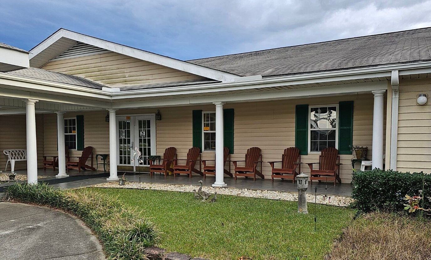 Exterior view of a senior living facility with seating area