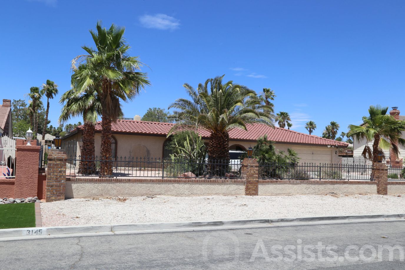 Exterior view of a senior living facility with palm trees