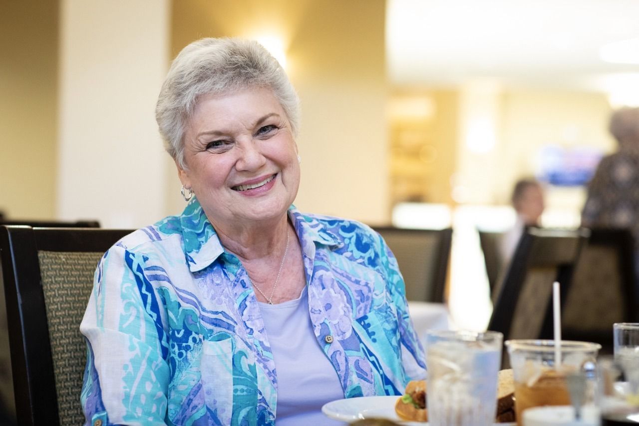 Inspirations of Peoria, assisted living in Peoria, AZ — Smiling senior woman enjoying a meal in a dining area
