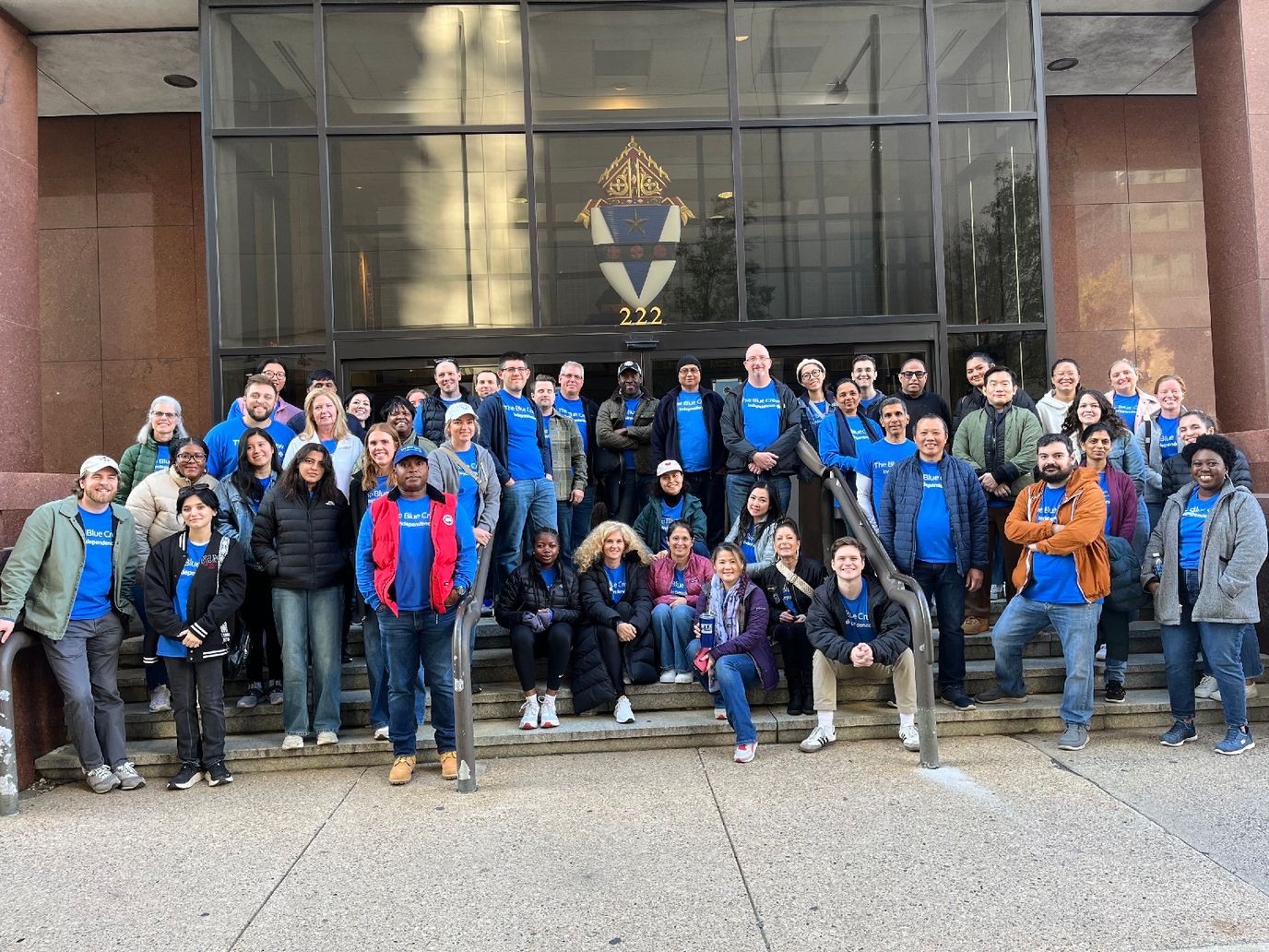 Group photo of staff in front of the facility