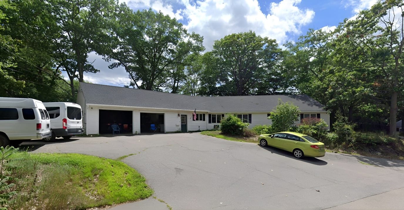 Exterior view of the facility with cars and entrance