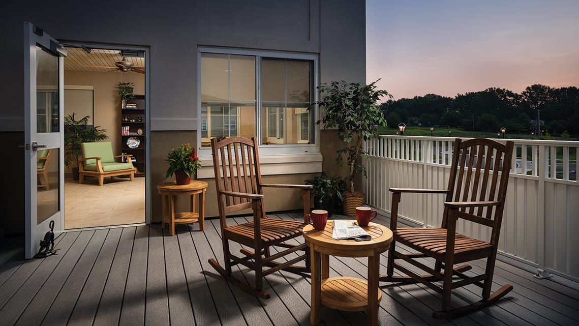 Cozy outdoor balcony with rocking chairs and plants