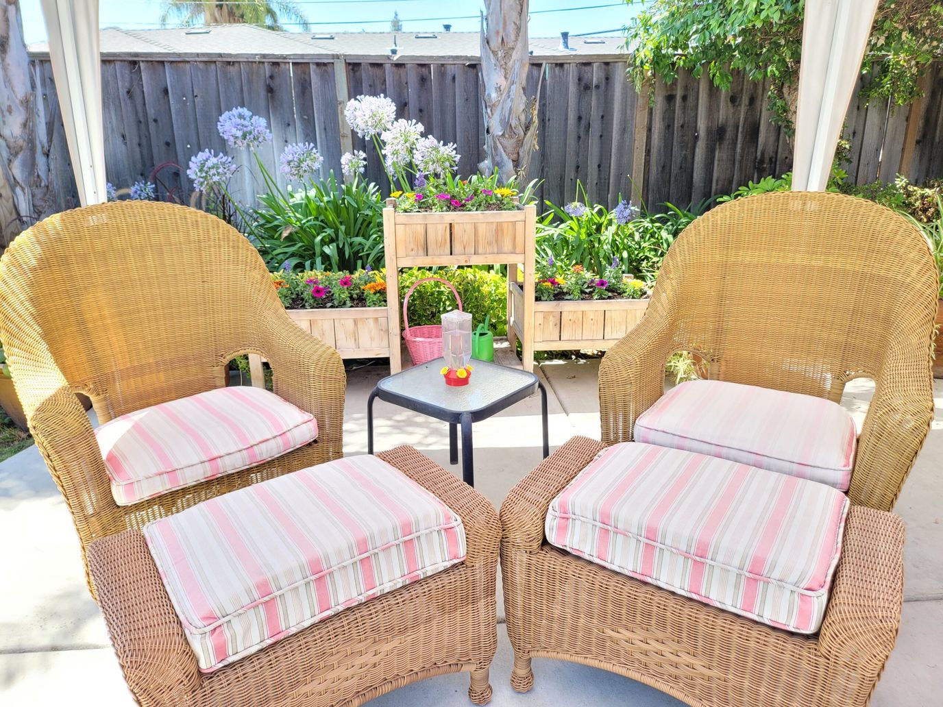 Cozy outdoor seating area with flowers.