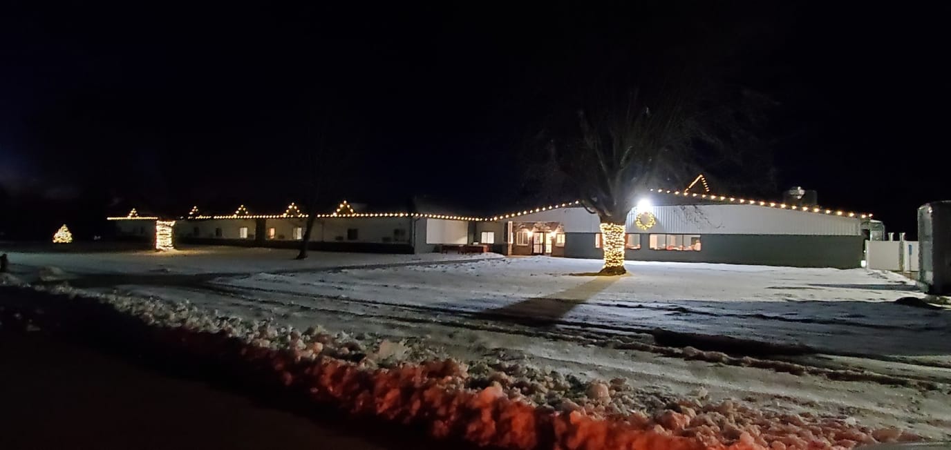 Exterior view of the facility decorated with lights at night