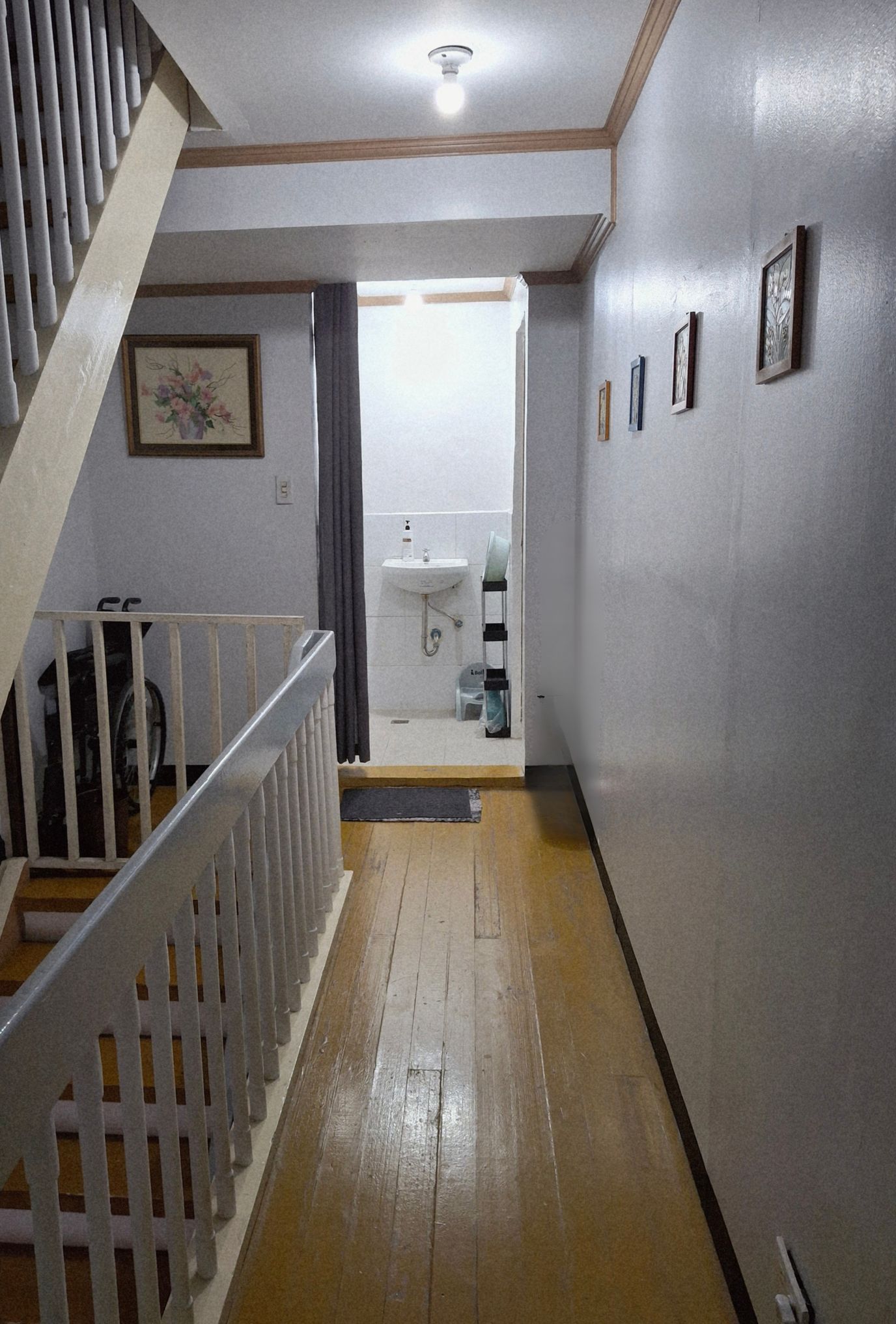 A well-lit hallway leading to a bathroom