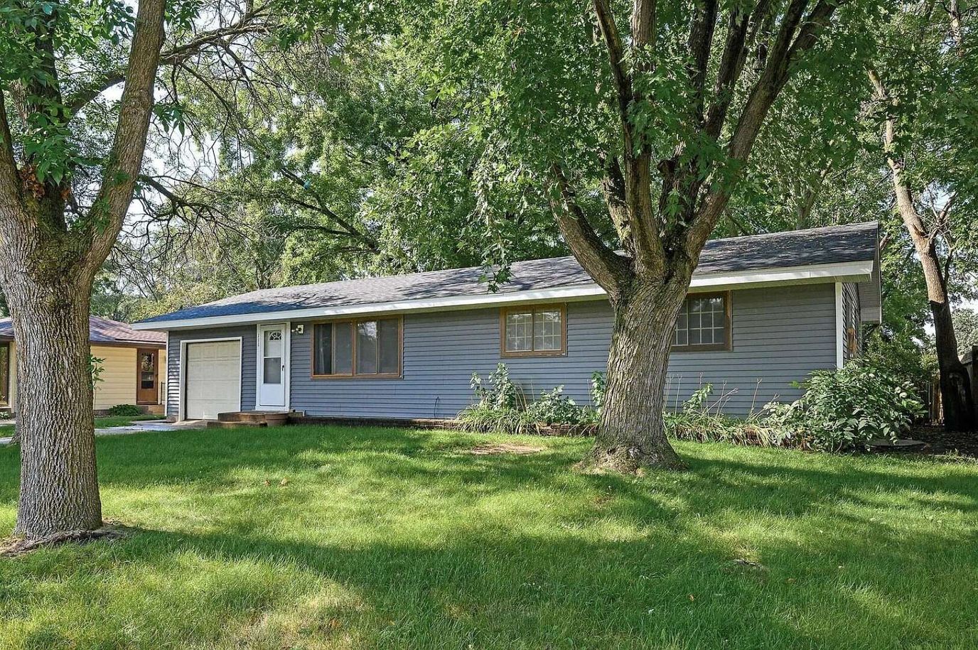 Exterior view of a senior living home with trees