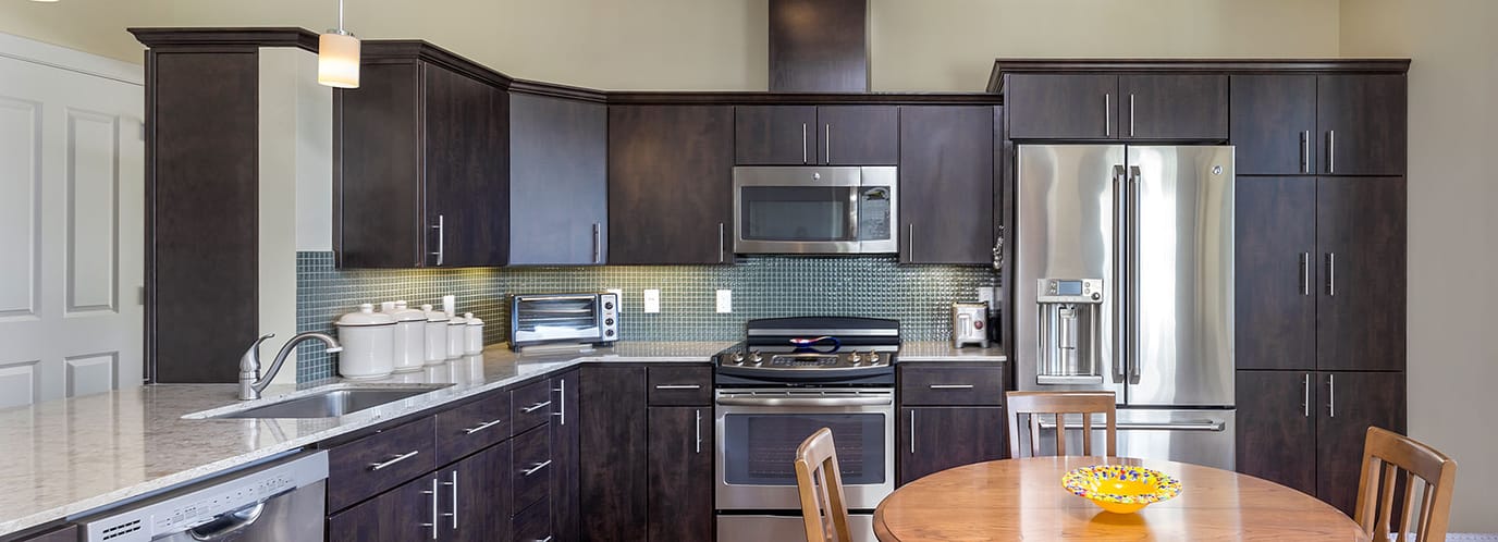 Modern kitchen with wood cabinets and appliances.