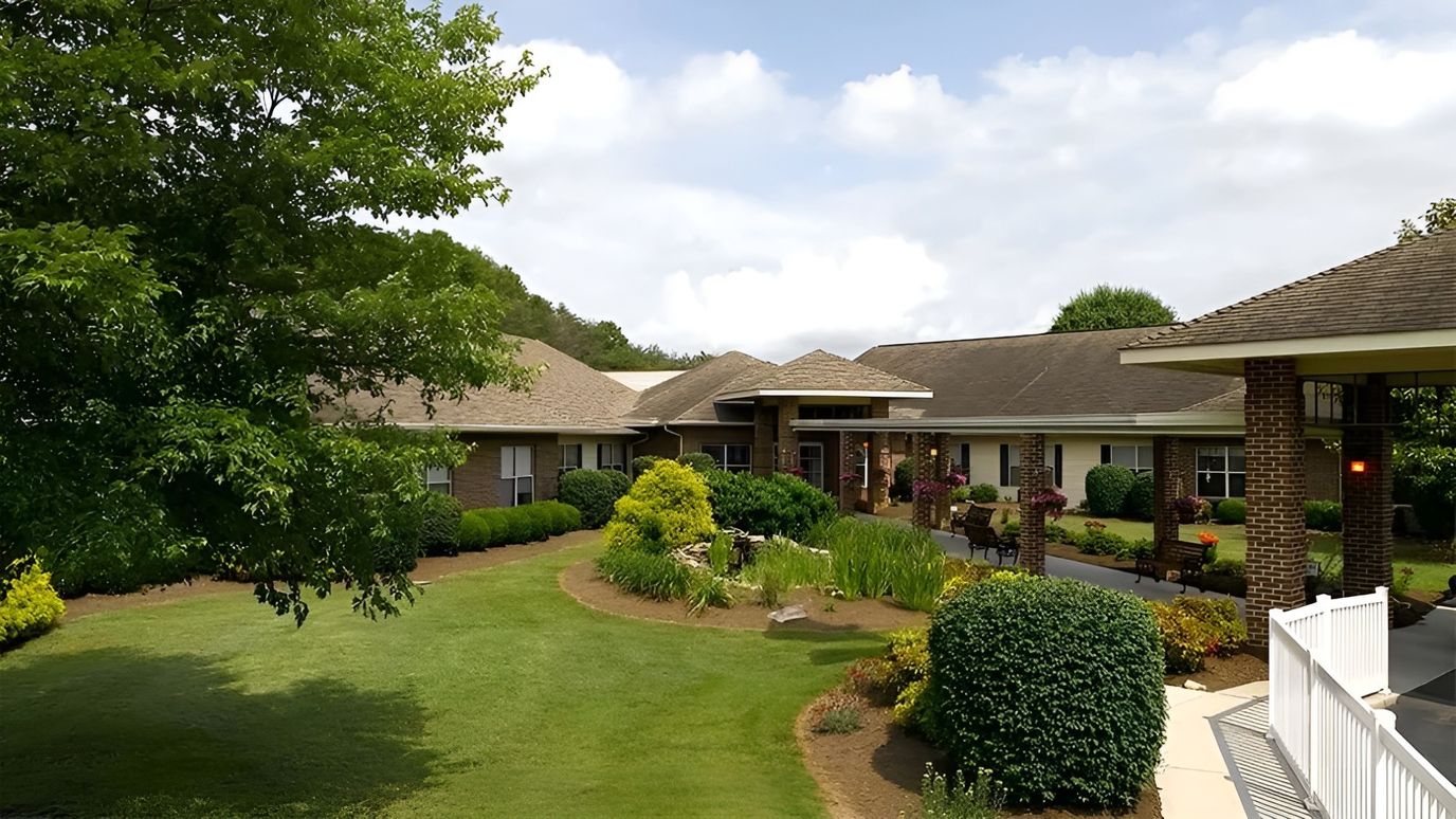 Exterior view of a senior living facility with landscaped gardens