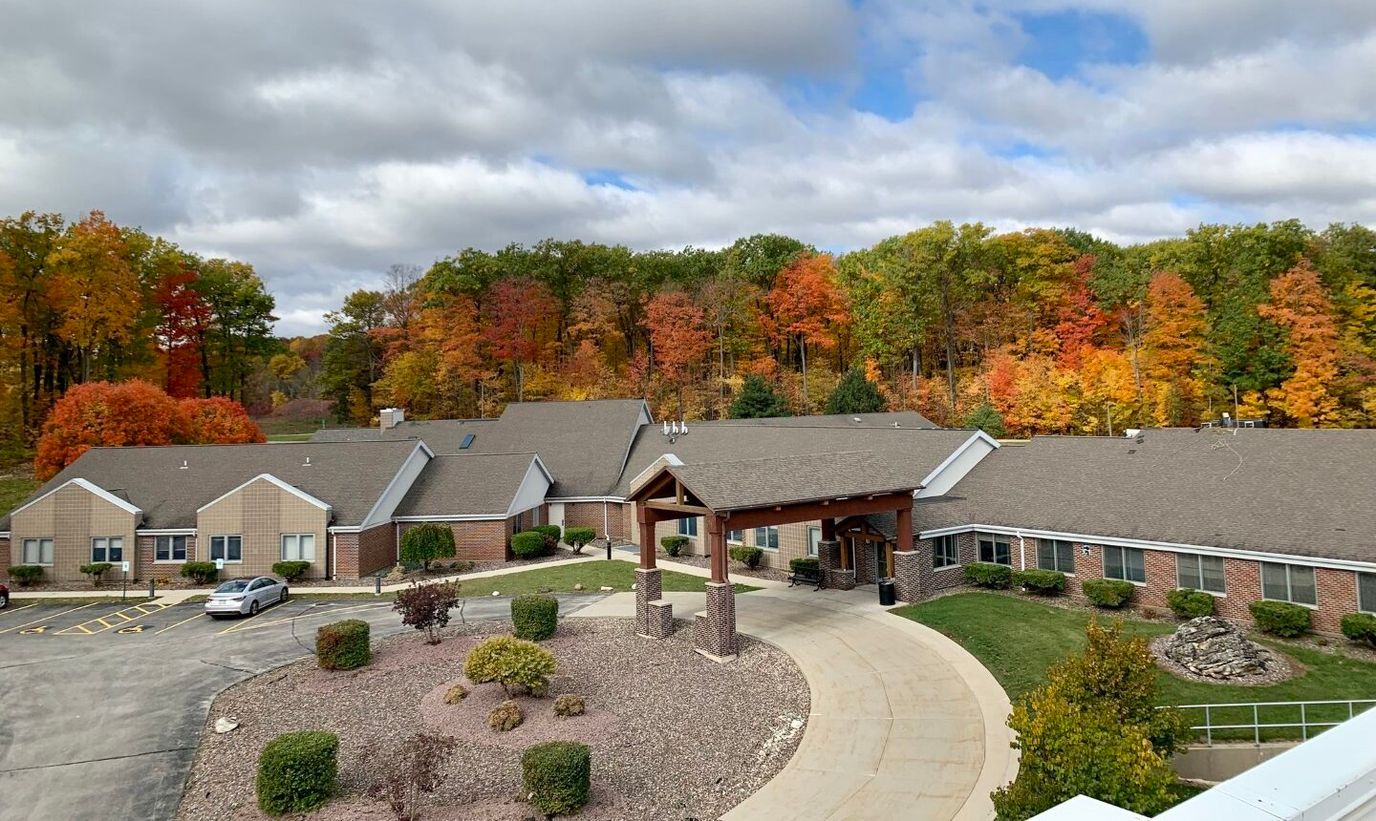 Exterior view of the facility surrounded by fall foliage