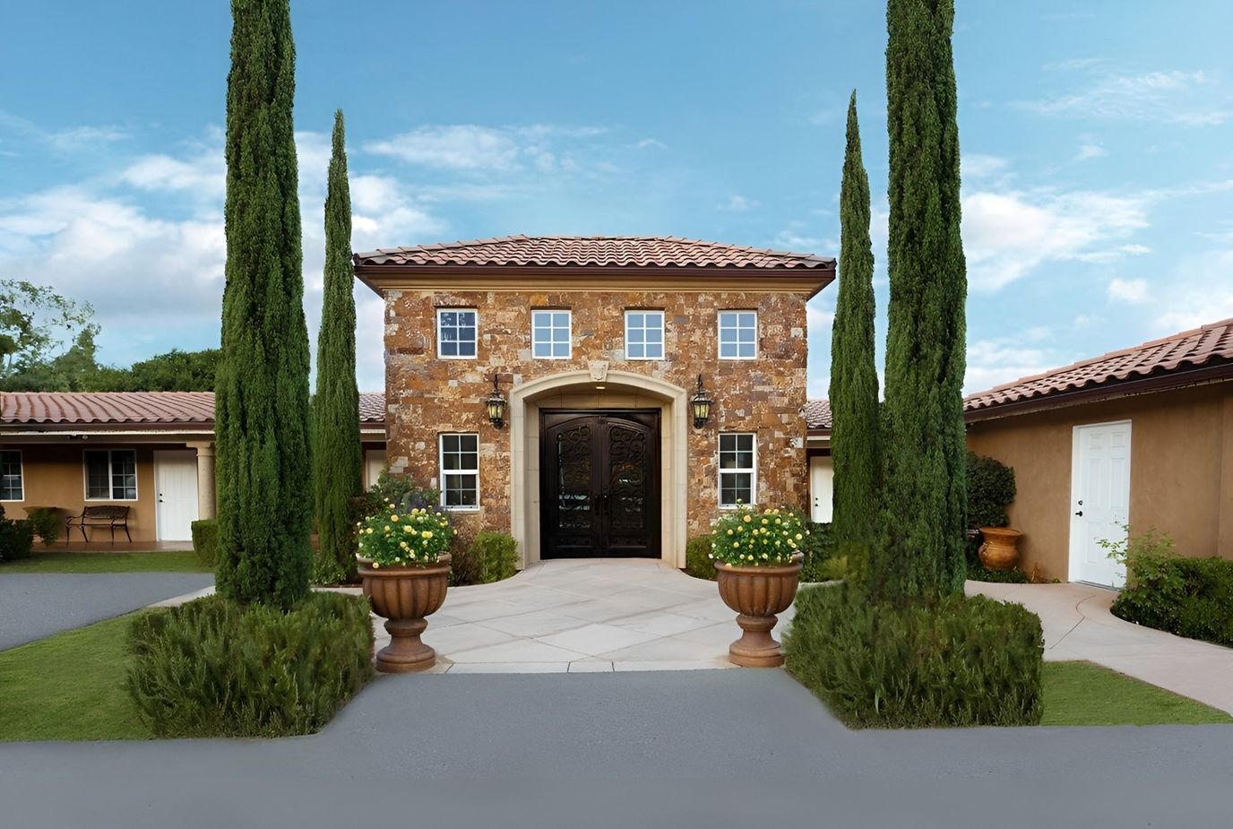 Exterior view of a senior living facility with landscaped entrance