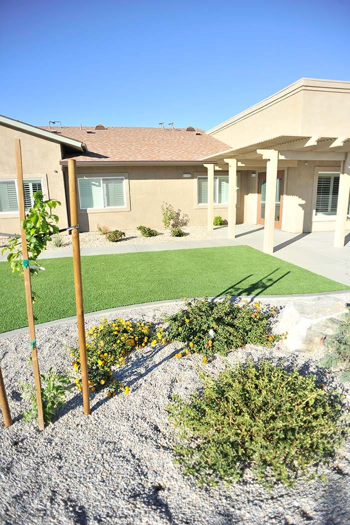 Exterior view of a senior living facility with landscaping