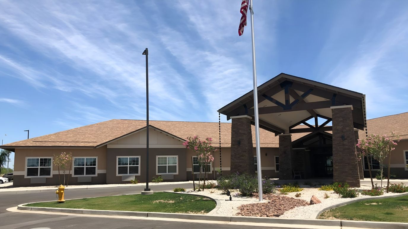 Exterior view of River Valley Estates with flag and landscaping