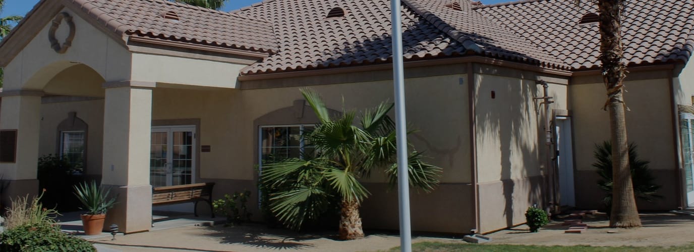 Exterior view of Hadley Villas with palm trees.