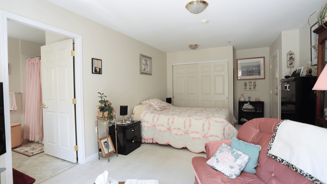 Cozy resident room with a bed and seating area.