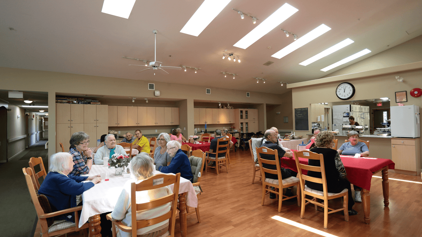 Common area with residents enjoying a meal together.