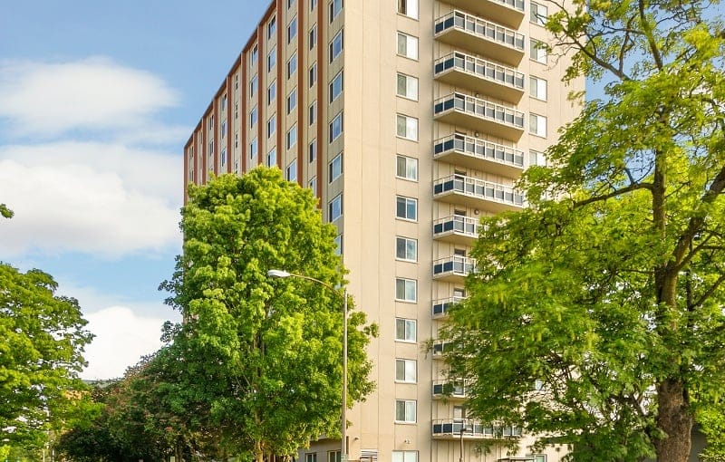 Exterior view of Hadley Villas building surrounded by trees.