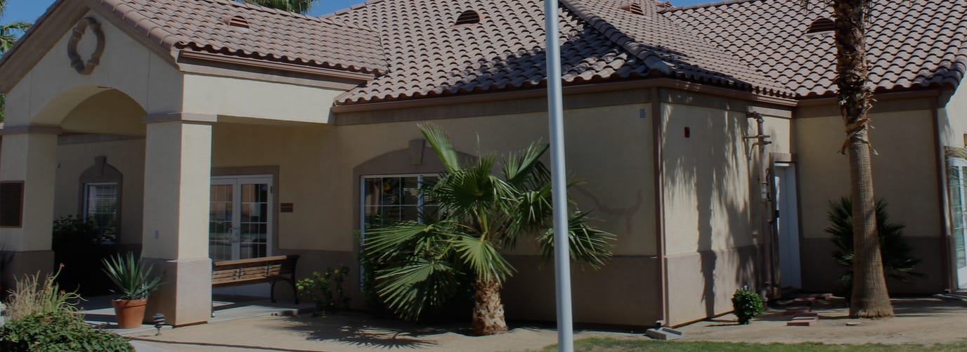 Exterior view of Hadley Villas with palm trees.