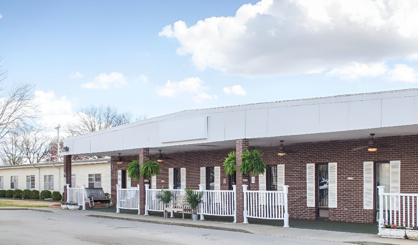 Exterior view of a senior living facility with porch.
