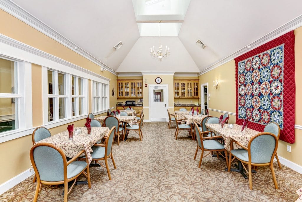 Bright dining room with tables set for a meal