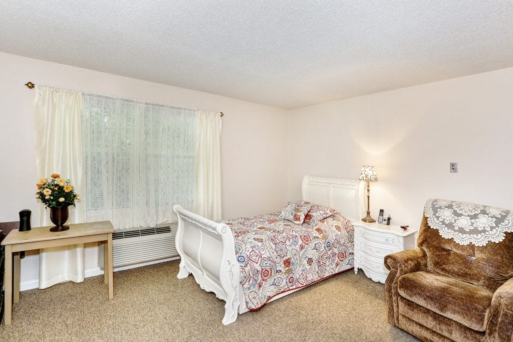 Cozy private room with a bed and armchair