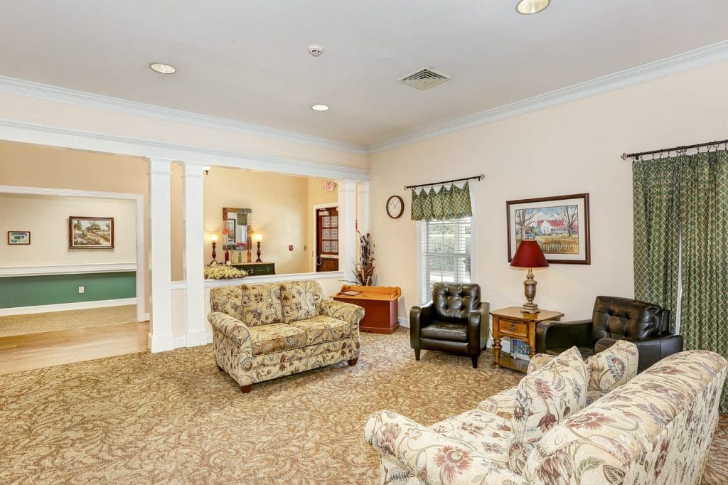 Cozy common area with floral couches and decor
