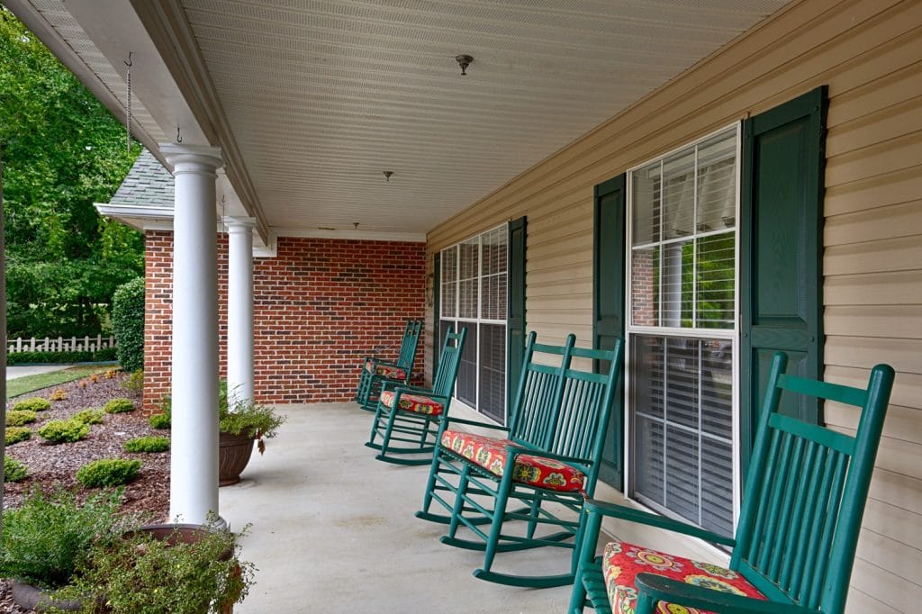 Porch area with rocking chairs and garden