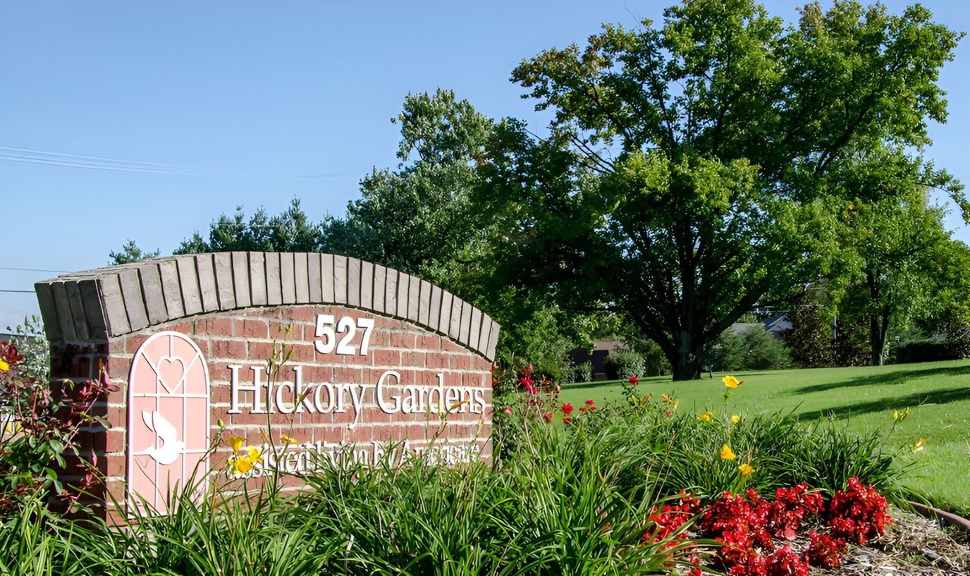 Sign for Hickory Gardens Assisted Living with flowers