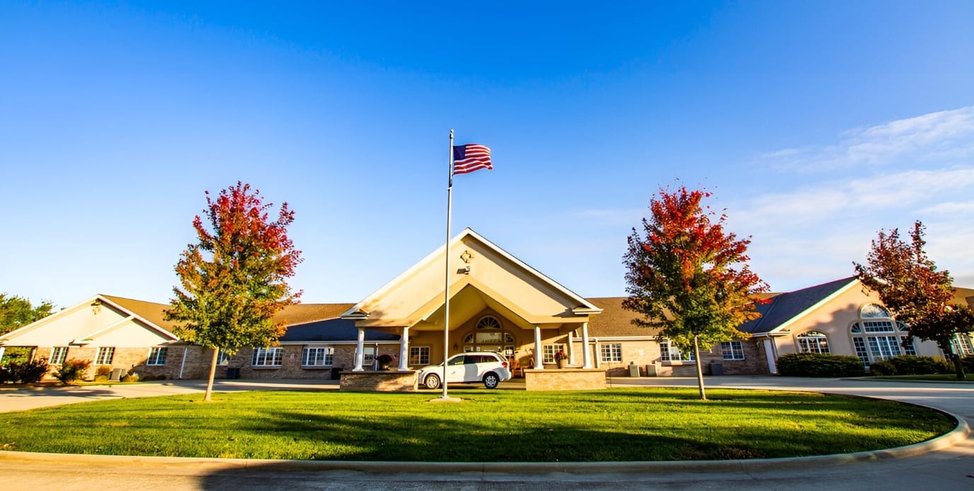 Exterior view of Hickory Estates with trees and flag