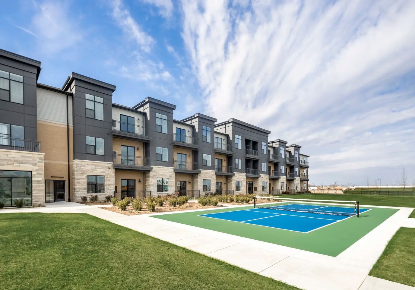 Exterior view of a senior living facility with green space