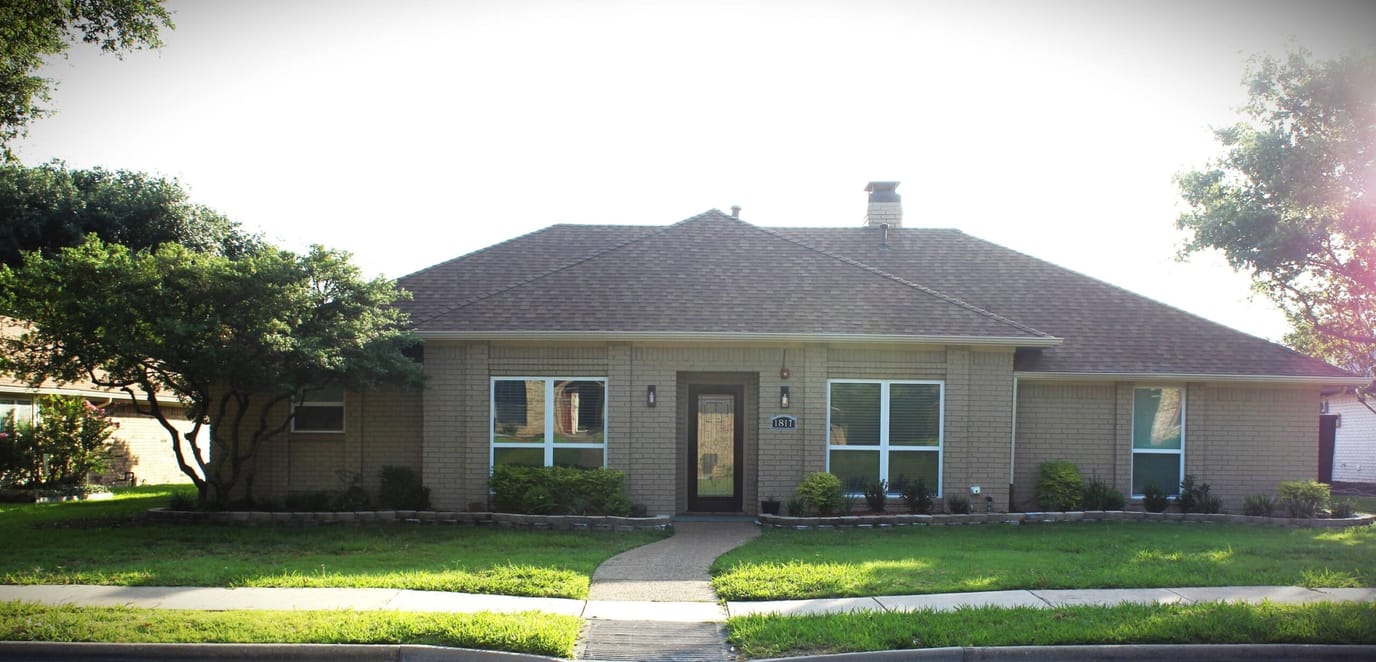 Exterior view of a residential facility with landscaped front yard