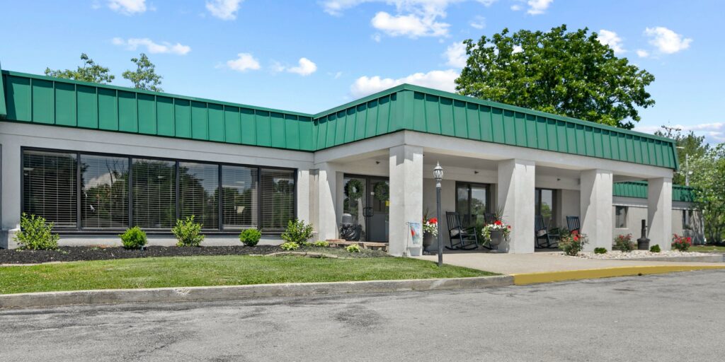 Exterior view of a senior living facility with greenery