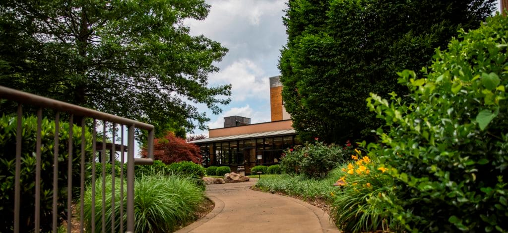 Pathway leading to a garden and facility exterior