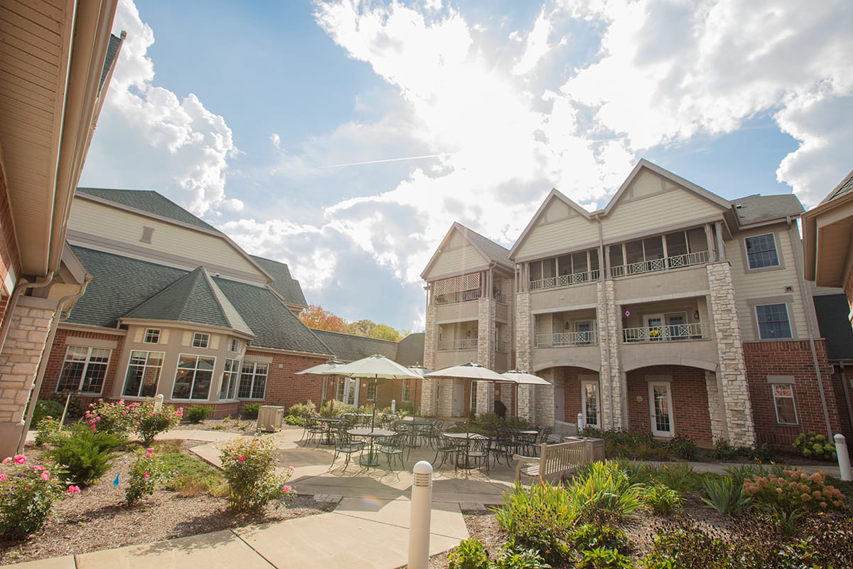 Exterior view of a senior living facility with garden