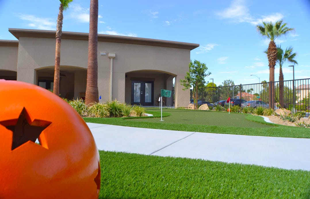 Outdoor putting green with a brightly colored ball