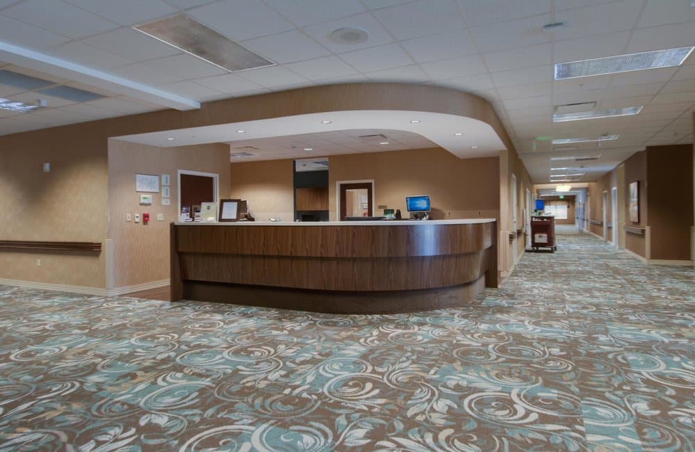 Lobby area with reception desk and carpeted flooring.