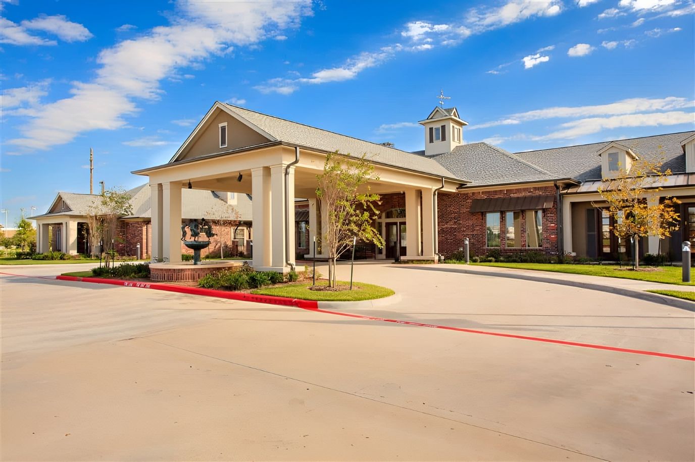 Exterior view of The Crescent facility with landscaping