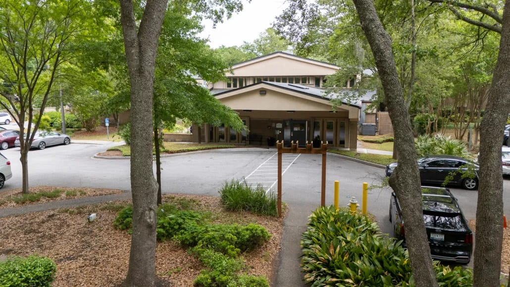 Entrance to the Ashley River Healthcare facility surrounded by greenery