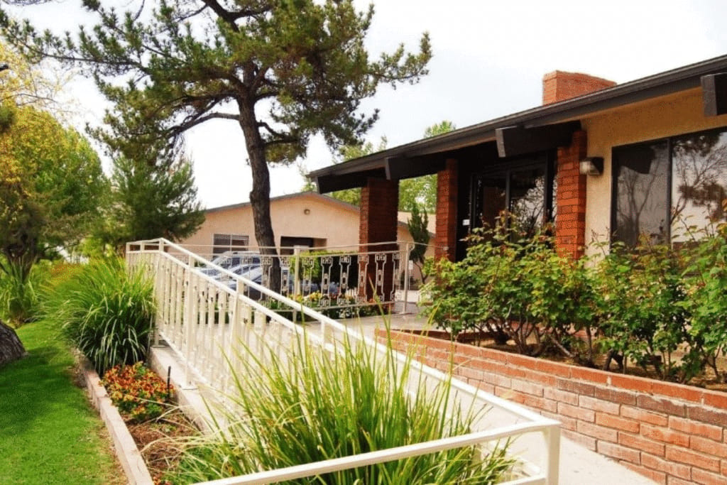 Exterior view of a senior living facility with landscaped entryway