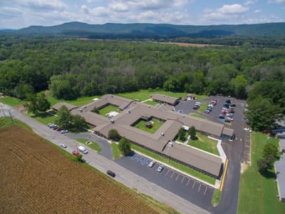 Aerial view of a senior care facility with surrounding nature
