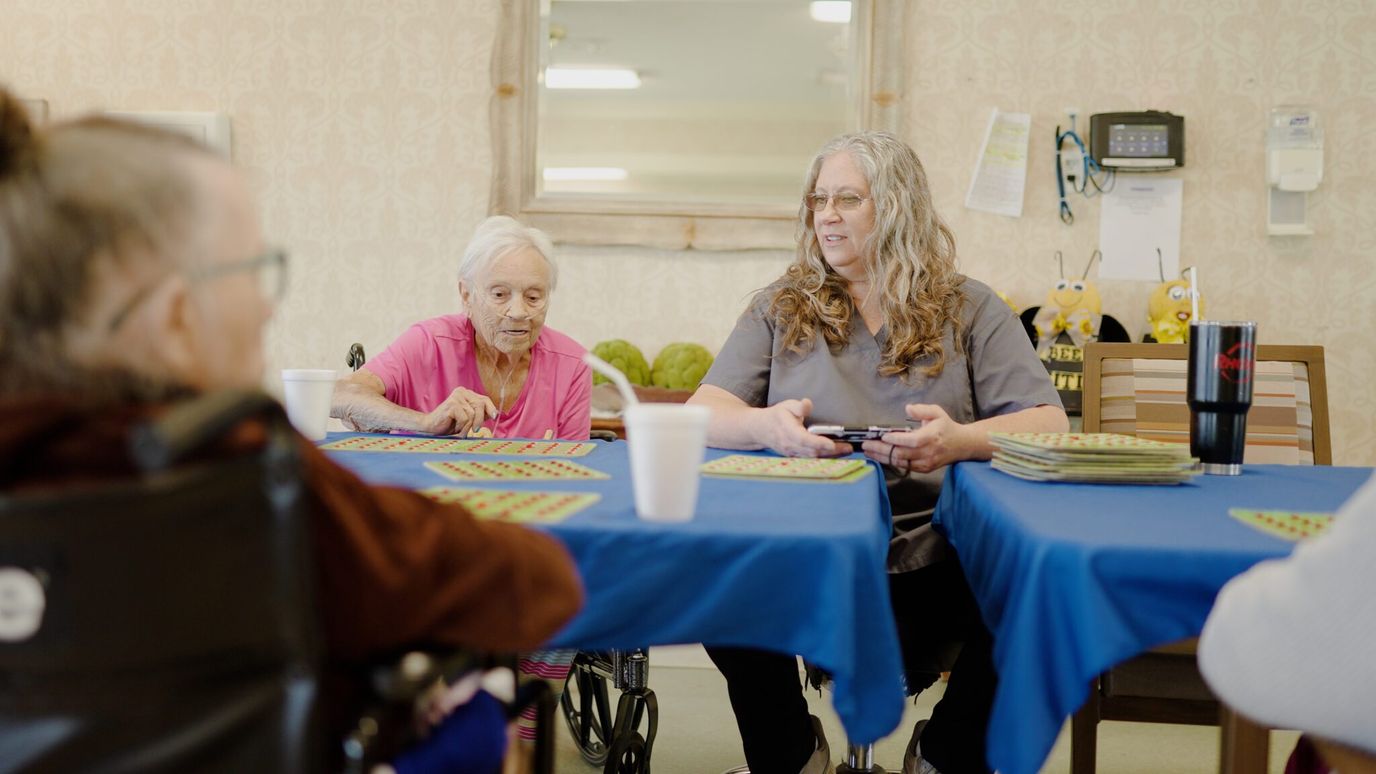 Residents playing a game together in an activity room