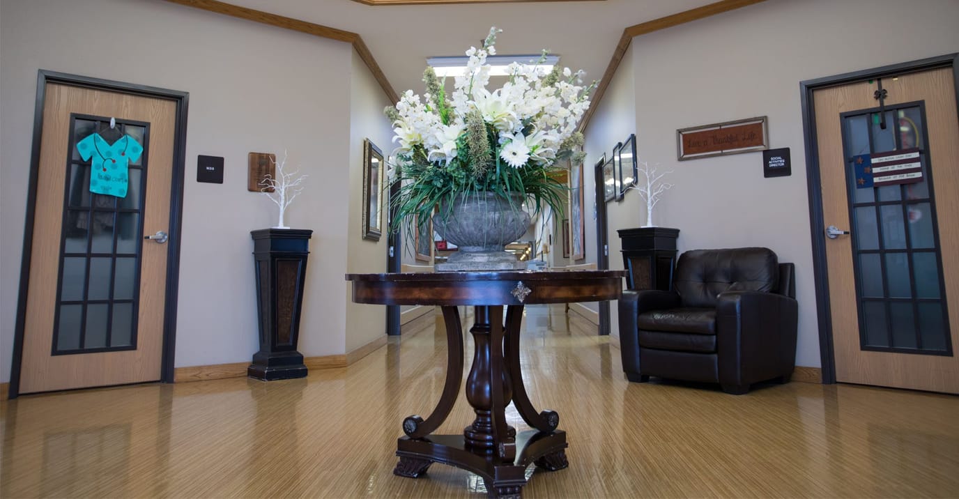 Indoor hallway with a floral arrangement and seating
