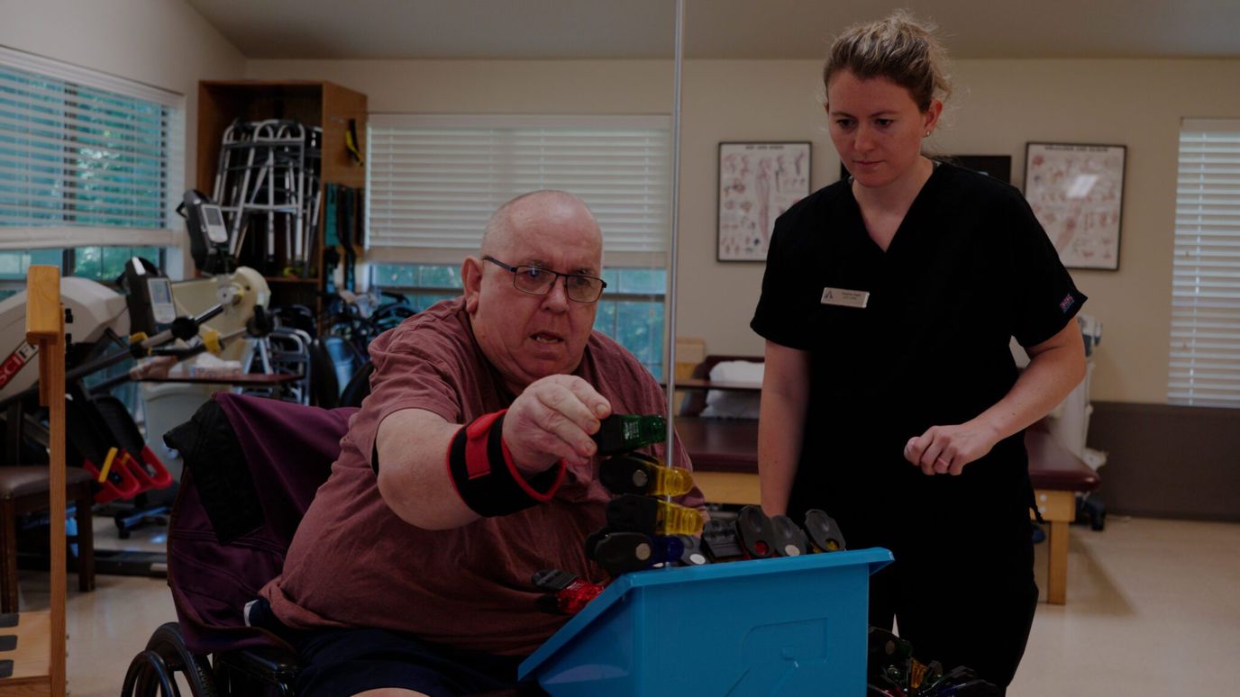 Therapist assisting a resident with an activity