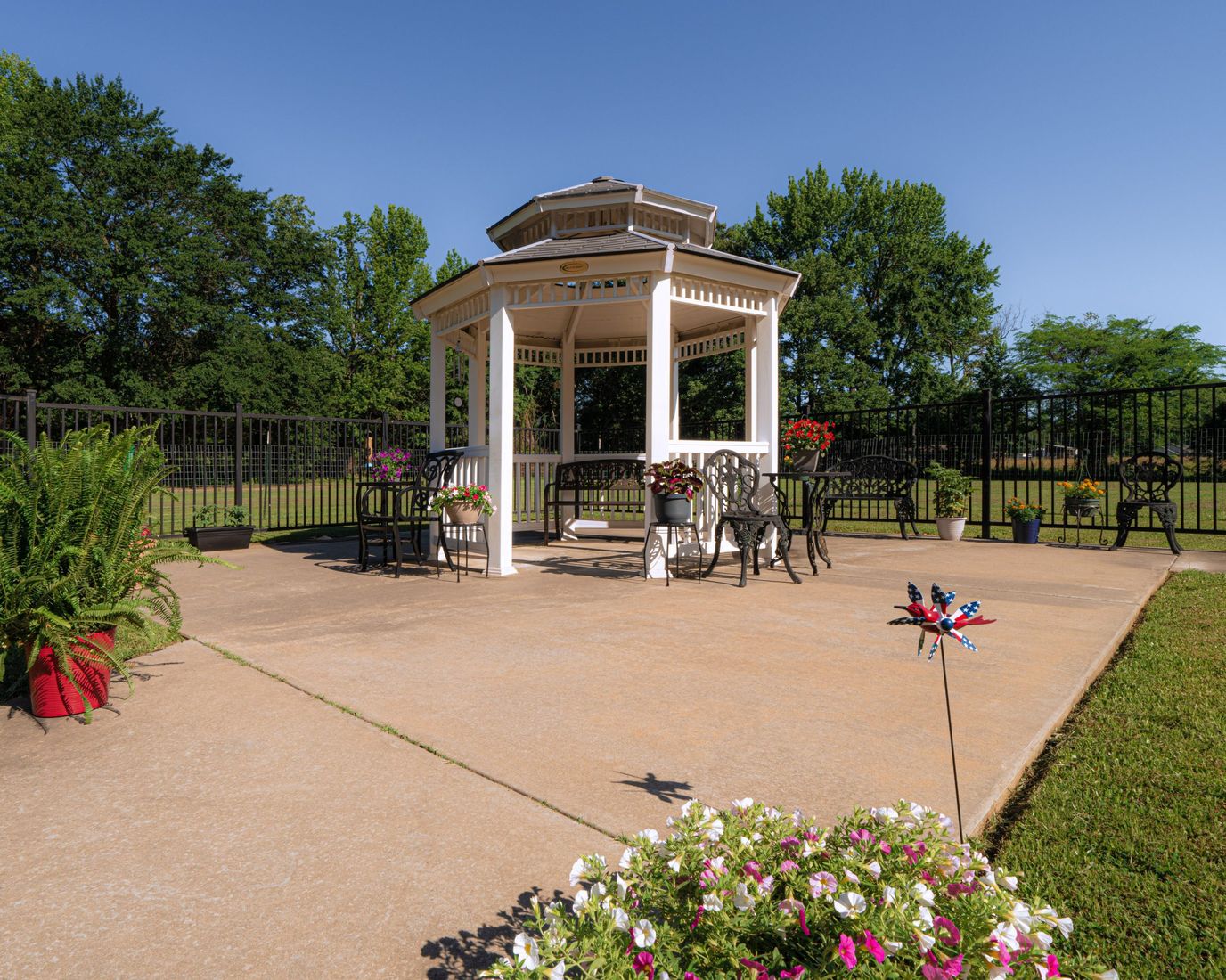 Outdoor gazebo with seating and flowers