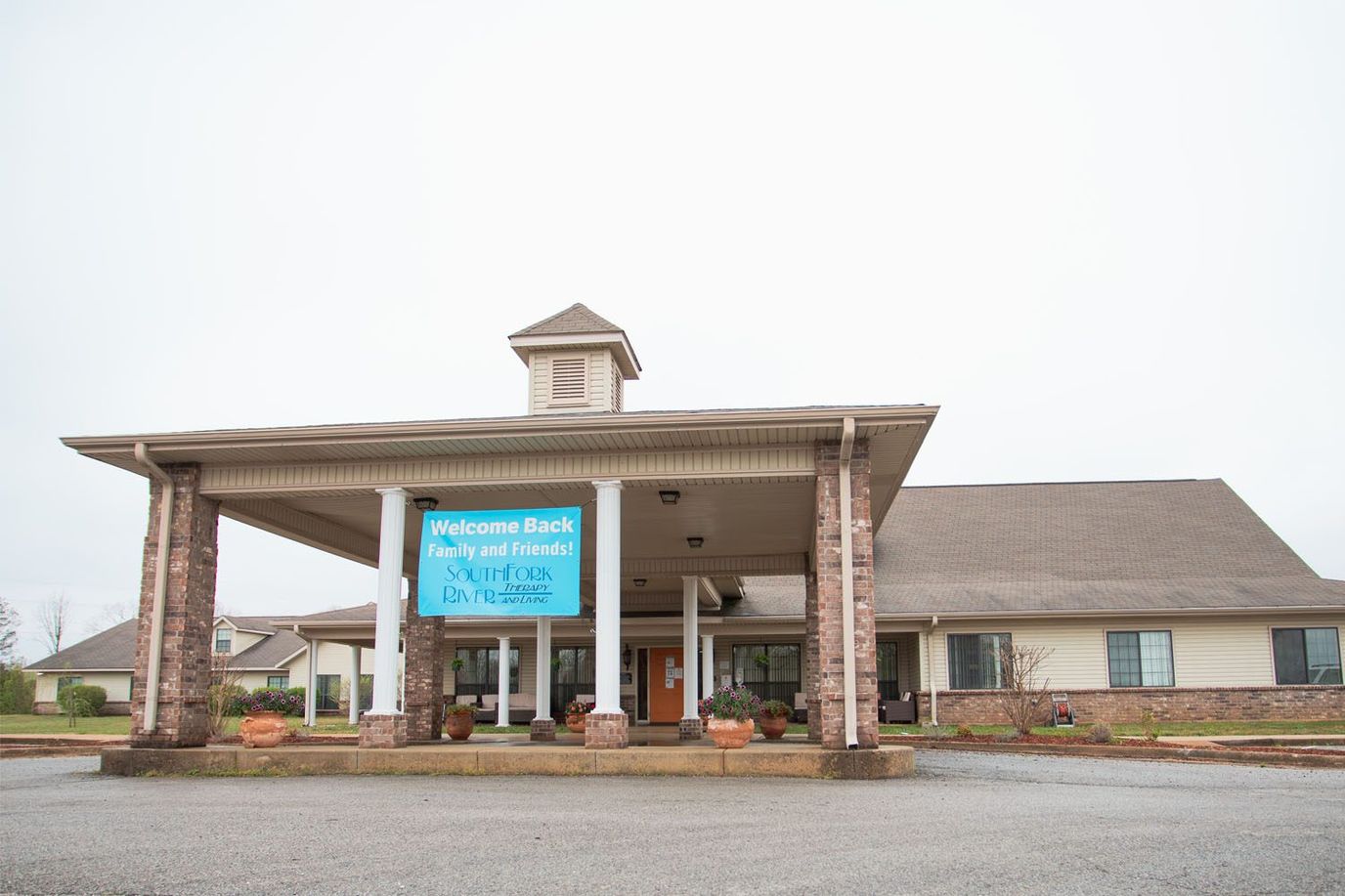Front entrance of a senior living facility with signage