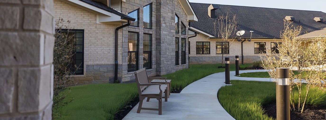 Walking path and outdoor seating area near the facility
